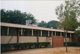 Classroom wing showing new rooftop package units and

original mechanical room at grade